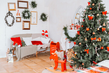 Cozy holiday living room decorated for Christmas with a tree and festive touches