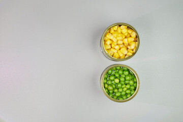 Very colorful canned vegetables, in a zenithal or top shot with a gray background and space for text