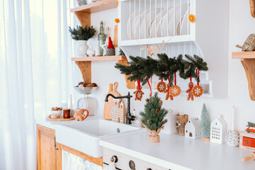 Cozy kitchen decorated for the holidays with festive ornaments and greenery