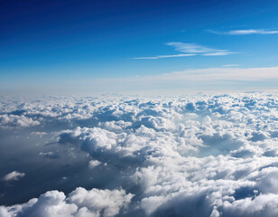 A breathtaking view of fluffy white clouds stretching towards the horizon in a deep blue sky.