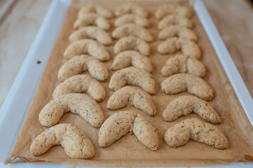 Homemade fresh baked and hot vanilla crescents on a baking tray