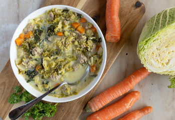 Savoy cabbage soup or stew with minced meat and vegetables fresh and homemade cooked on a plate...