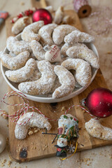 Homemade vanilla crescents, delicious german christmas cookies on a wooden board with decoration