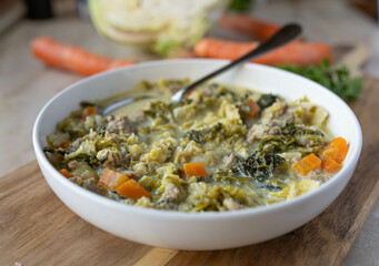 Savoy cabbage soup or stew with minced meat and vegetables fresh and homemade cooked on a plate...