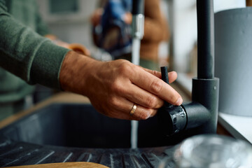 Close up of man doing  dishes in  kitchen.