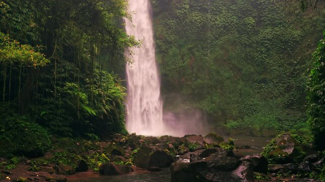 Bali waterfall Air Terjun Nungnung breathtaking 50-meter waterfall Bali's lush highlands. One of the most popular travel destinations Bali, Indonesia 4K