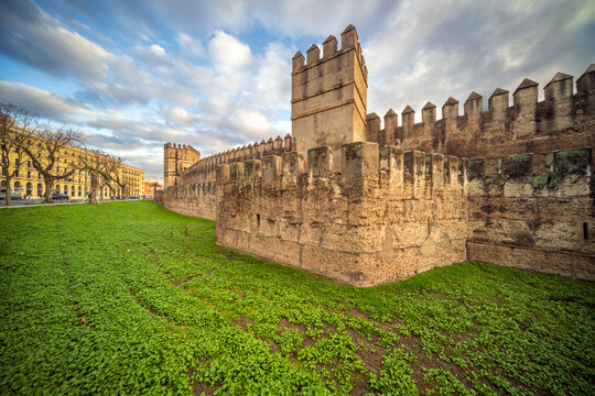 Historic Murallas de la Macarena in Sevilla, Spain with Lush Green Scenery