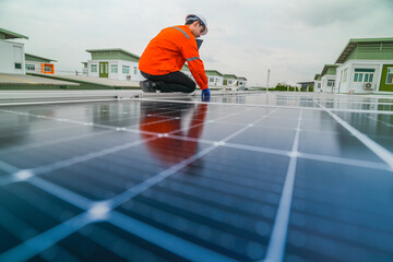 Fototapeta premium engineer man inspects construction of solar cell panel or photovoltaic cell by electronic device. Industrial Renewable energy of green power. factory worker working on tower roof.