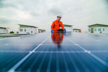 engineer man inspects construction of solar cell panel or photovoltaic cell by electronic device. Industrial Renewable energy of green power. factory worker working on tower roof.