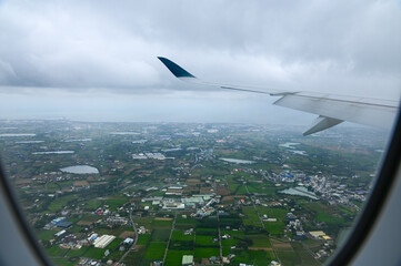 Naklejka premium Looking from airplane of the Taipei city view, Taiwan. Ariel view of Taipei cityscape. Stunning nature and cityscape. Travel concept.