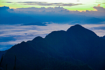 Fototapeta premium Sunset over mountain peaks scenic landscape nature photography cloudy sky aerial view tranquility and beauty