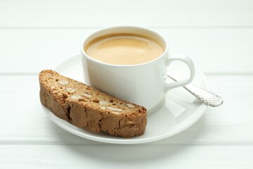 Traditional Italian almond biscuit (Cantucci) and coffee on white wooden table, closeup
