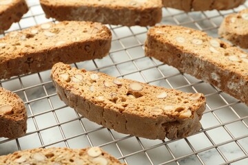 Traditional Italian almond biscuits (Cantucci) on white marble table, closeup