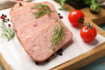 Pieces of tasty canned meat, dill, peppercorns and tomatoes on table, closeup
