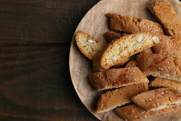 Tasty almond biscuits (Cantuccini) on wooden table, top view. Space for text