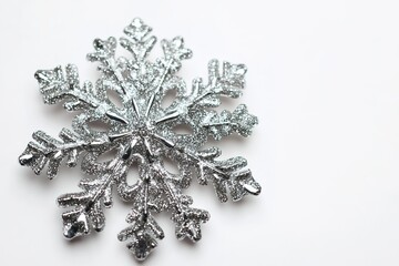 Sparkling silver snowflake on white background