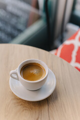 Cup of black coffee on a table in a cafe.