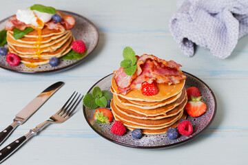 Stack of pancakes  with savory topping and berries at breakfast