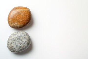 Smooth pebbles on white with ample space for text.