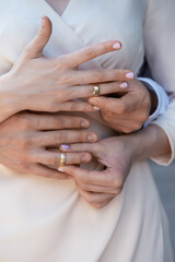 Hands of newlyweds with wedding rings