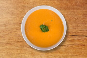 A bowl of creamy tasty fresh soup on the desk