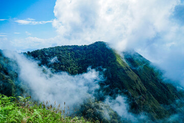 Majestic mountain peaks enveloped in clouds nature's serenity landscape photography outdoor...