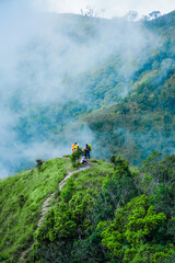 Obraz premium Adventurous hikers exploring lush mountain trails scenic cloud forest nature photography outdoor adventure elevated perspective conservation awareness