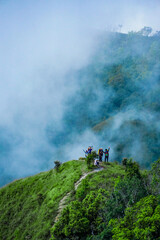 Adventurous hiking journey mountain peak outdoor activity foggy environment group perspective team spirit and nature exploration