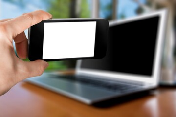 Smartphone with a blank screen on office desk background