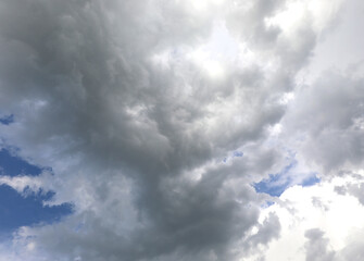 clouds that are opening up leaving a few glimpses of blue sky