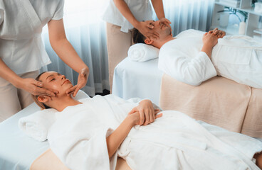 Caucasian couple enjoying relaxing anti-stress head massage and pampering facial beauty skin...