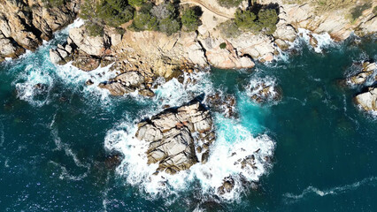 Close up aerial view from drone of sea waves crashing on the rocks and cliffs in Spanish seascape, 4K	