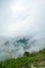 Misty mountain scenery hilltop viewpoint natural landscape foggy environment serene atmosphere nature photography