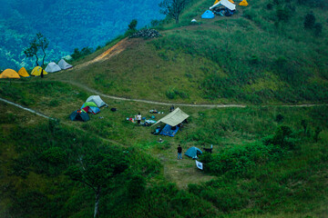 Camping adventure mountain hillside outdoor activity scenic nature aerial view exploration and relaxation