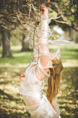 The woman's body is wrapped in cellophane film. Ecological nature concept.