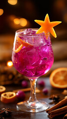 Crystal glass filled with pink hibiscus and lemon gin, garnished with dried orange slices and star anise. Cinnamon sticks add depth, while fresh citrus sits alongside, creating a festive atmosphere.