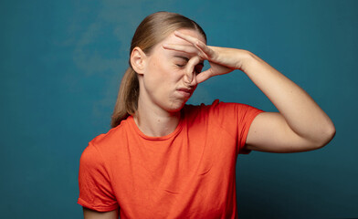 feeling disgusted, holding nose to avoid smelling a foul and unpleasant stench