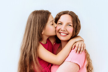 Heartwarming Moment Between Mother And Daughter With Loving Embrace. 10 eyars girl kiss hem mama in cheek