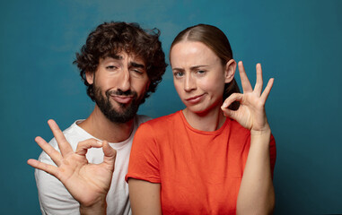 feeling happy, relaxed and satisfied, showing approval with okay gesture, smiling