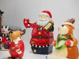 Christmas ceramic figures of Santa Claus. American holiday Christmas decoration. Santa Claus in family interior decorating a home.
