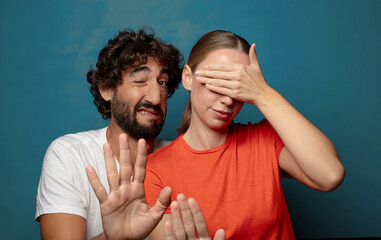 covering face with hand and putting other hand up front to stop camera, refusing photos or pictures