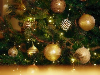 Christmas decoration hanging on the tree. Festive Christmas atmosphere when winter arrives. Golden...
