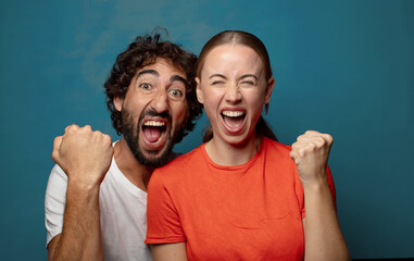 shouting aggressively with an angry expression or with fists clenched celebrating success