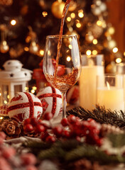 Festive red wine glass surrounded by Christmas decorations, creating a cozy holiday vibe. Perfect for Christmas, holiday season, festive celebrations, winter drinks, seasonal parties and holiday cheer