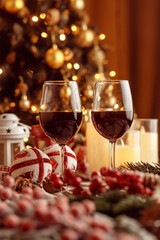 Festive red wine glass surrounded by Christmas decorations, creating a cozy holiday vibe. Perfect for Christmas, holiday season, festive celebrations, winter drinks, seasonal parties and holiday cheer
