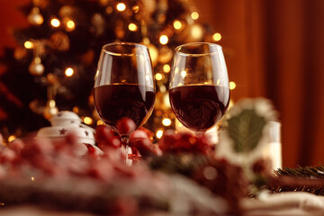 Festive red wine glass surrounded by Christmas decorations, creating a cozy holiday vibe. Perfect for Christmas, holiday season, festive celebrations, winter drinks, seasonal parties and holiday cheer