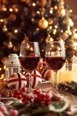 Festive red wine glass surrounded by Christmas decorations, creating a cozy holiday vibe. Perfect for Christmas, holiday season, festive celebrations, winter drinks, seasonal parties and holiday cheer