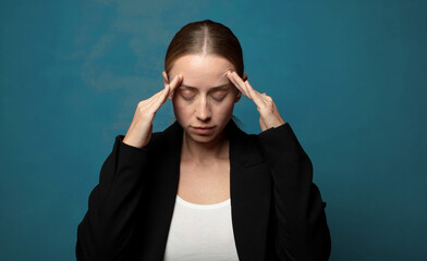 looking concentrated, thoughtful and inspired, brainstorming and imagining with hands on forehead