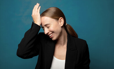 laughing and slapping forehead like saying d’oh! I forgot or that was a stupid mistake