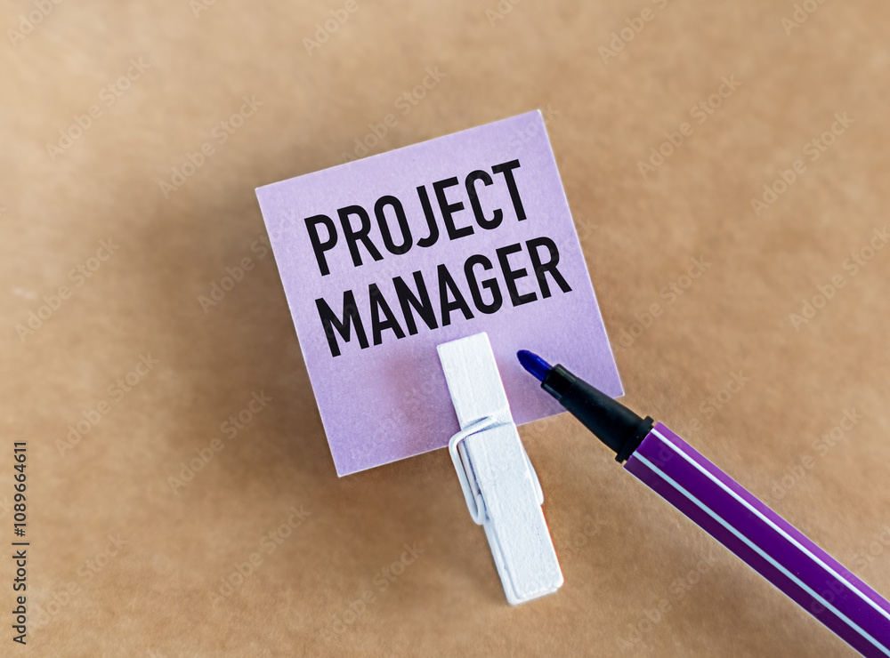 Poster project manager text on a lilac card with a marker on a beige background